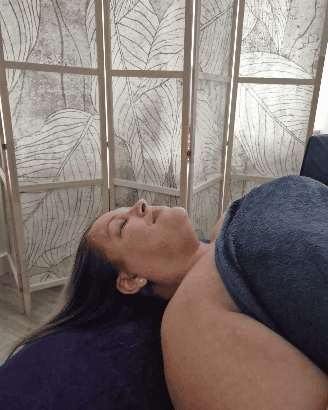 Louise Morgan receiving a relaxing massage in a serene setting.